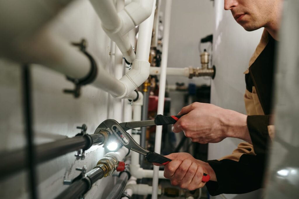 Plumbers maintaining commercial plumbing pipes in Aurora