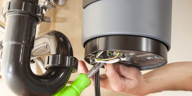 Technician repairing the heating element of a water heater in Aurora